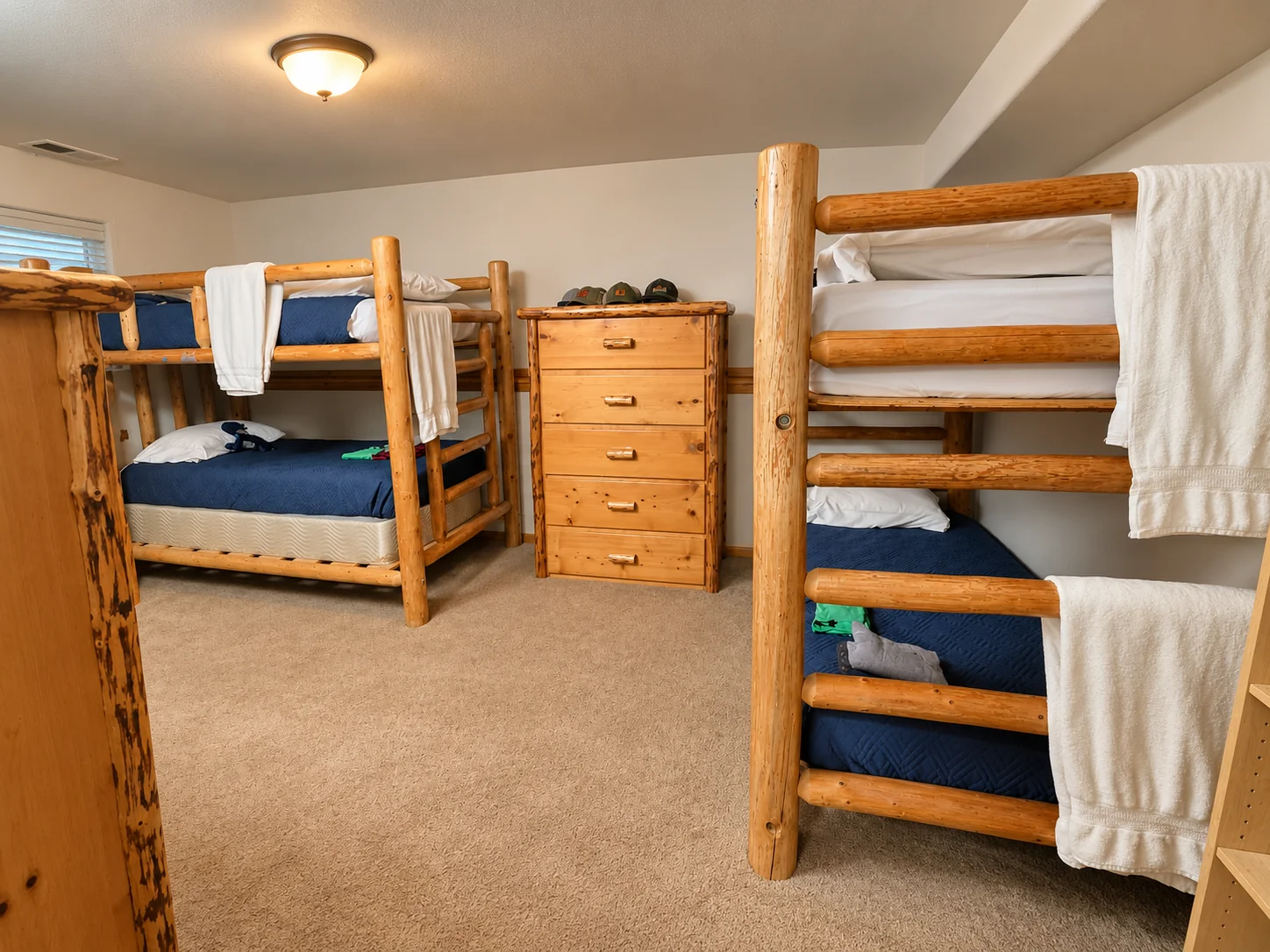 Campus bedroom with bunk beds and wooden dressers