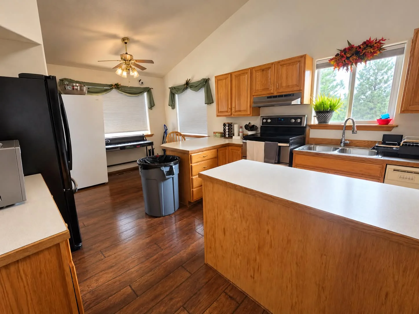 Campus kitchen with wooden cabinets and a breakfast counter